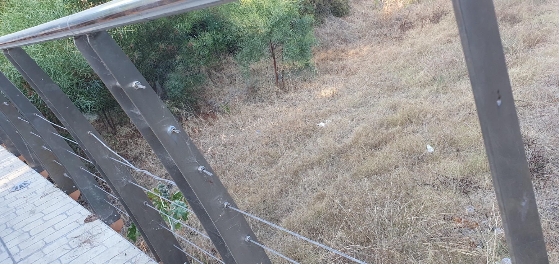 Damaged and missing safety cables on footbridge